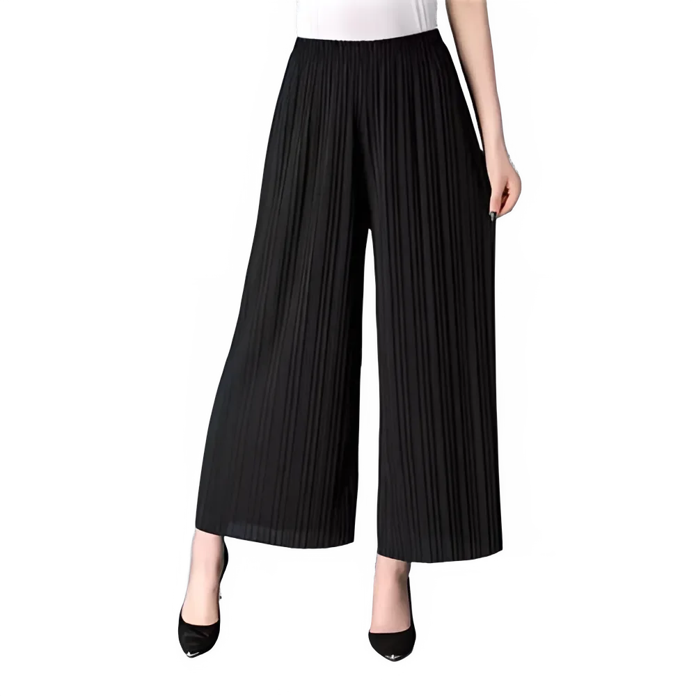 Woman wearing high-waisted black pleated wide-leg pants and black heels