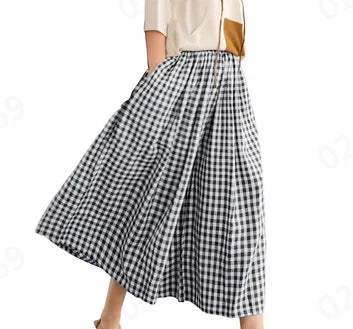 Woman wearing black and white gingham midi skirt with light short-sleeve top