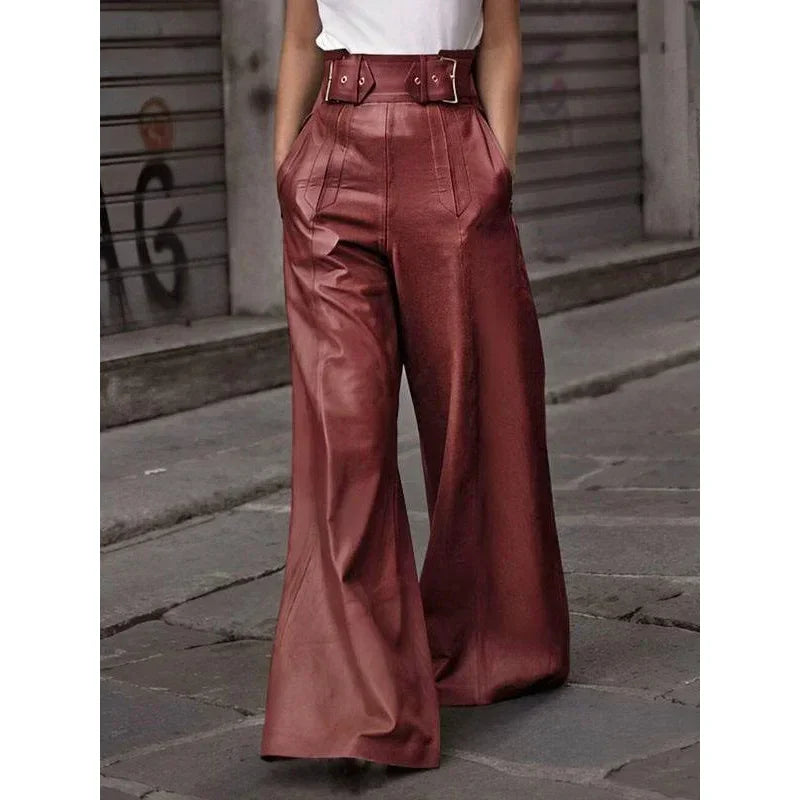 Woman wearing high-waisted wide-leg brown leather pants on a city street