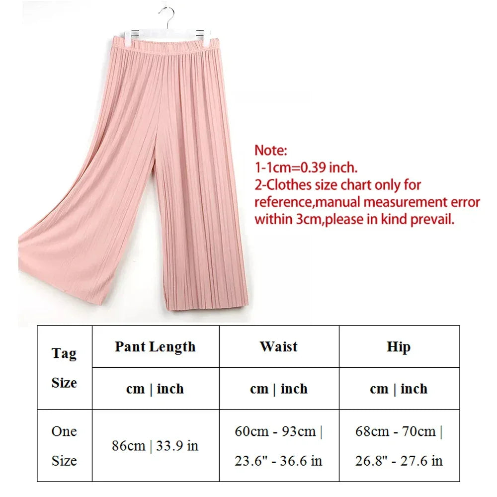 Pink pleated wide-leg pants with size chart and measurement details in centimeters and inches.