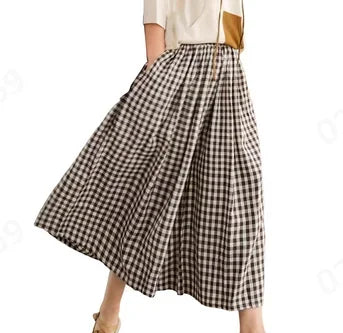 Woman wearing a black and white gingham checkered midi skirt with beige top
