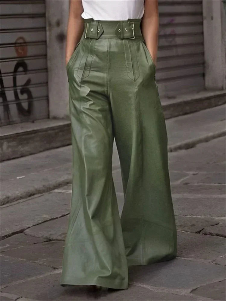 Wide leg high-waisted green leather pants with belt detail, worn on city street