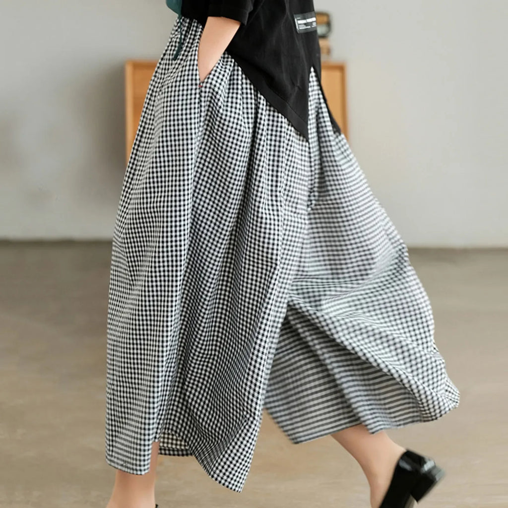 Woman wearing wide-leg black and white gingham plaid pants indoors