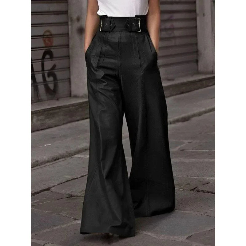 High-waisted black wide leg pants with belt, worn with a white top on city street