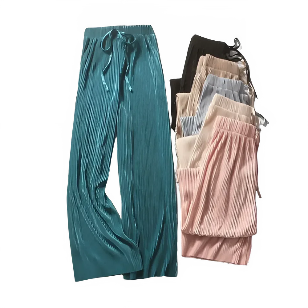 Assorted pleated lounge pants in teal, pink, beige, and black on black background
